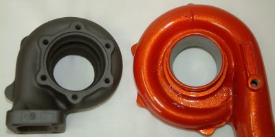 Turbo components showing a ceramic-coated housing and a coated exhaust housing in orange.