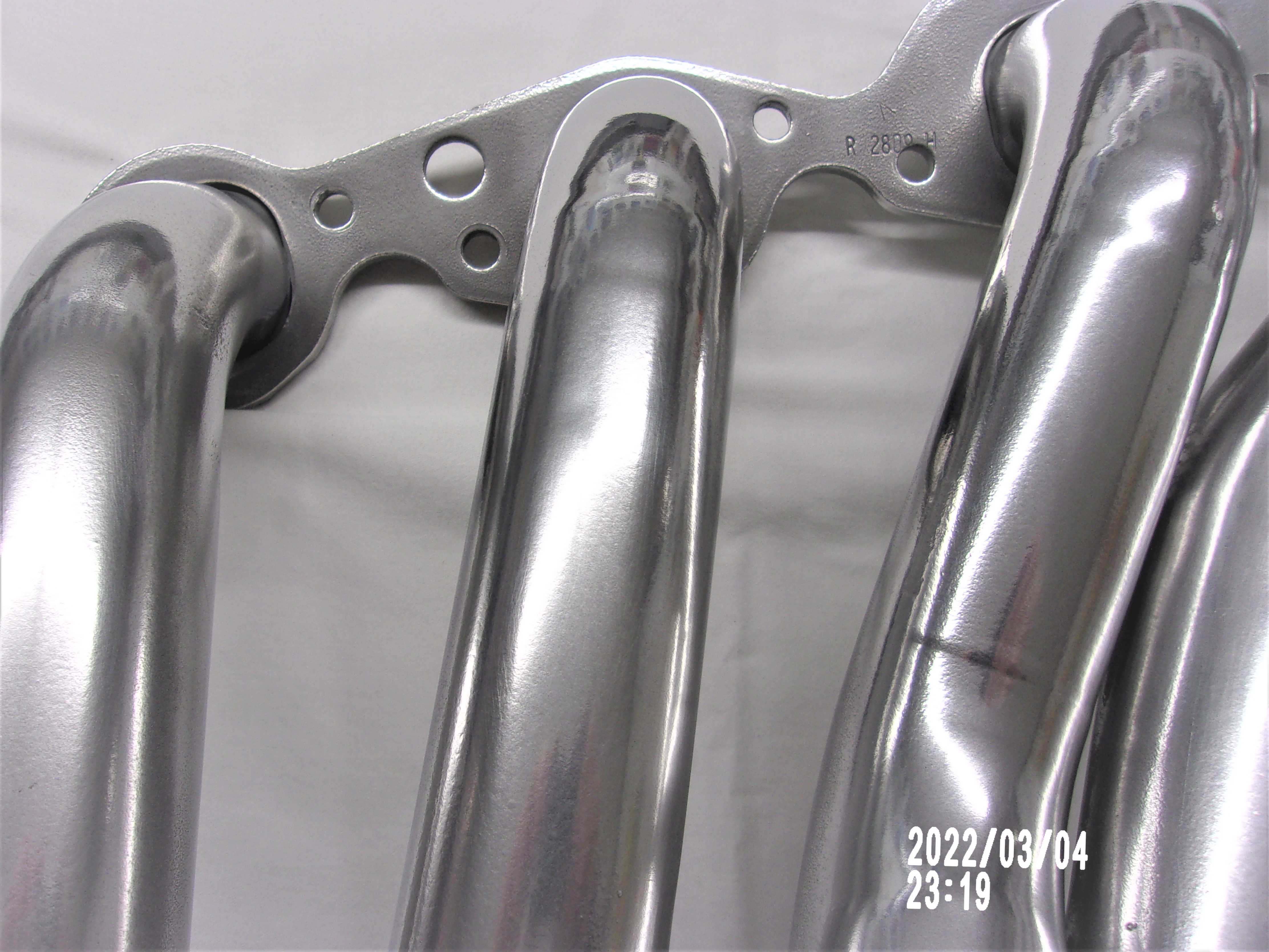 Close-up of polished header tubes with a metallic ceramic finish.